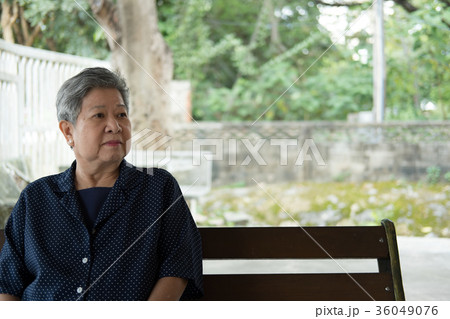 elder woman resting in garden. elderly female relaxing in park. senior leisure lifestyle outdoors. 36049076