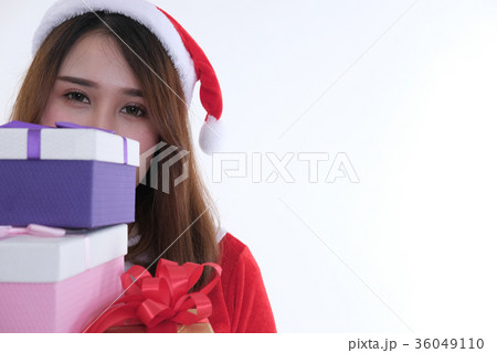 portrait of asian woman in santa claus dress on white background. girl with gift present box. christmas holiday. merry xmas celebration. 36049110