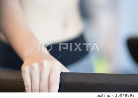 young woman execute exercise in fitness center. female athlete's hand while walking on treadmill in gym. sporty girl working out in health club. young woman execute exercise in fitness center. female athlete's hand while walking on treadmill in gym. sporty girl working out in health club. 36049998