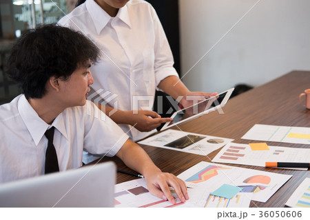 people working with tablet computer at workplace. businessman and businesswoman discussing new startup project at office. business people brainstorming for new creativity idea. teamwork, partnership concept people working with tablet computer at workplace. businessman and businesswoman discussing new startup project at office. business people brainstorming for new creativity idea. teamwork, partnership concept 36050606