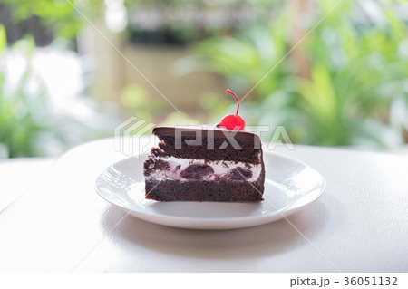 slice of dark chocolate cake cherry sauce. tasty delicious dessert on white plate. homemade bakery pastry 36051132