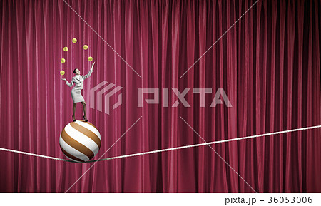 Businesswoman juggling with balls Businesswoman juggling with balls 36053006