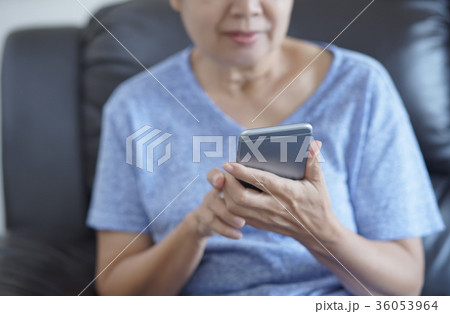 senior woman using mobile phone  making a  36053964
