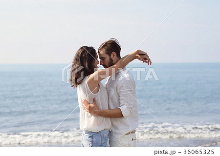 Romantic young couple on the beach kissing. Romantic young couple on the beach kissing. 36065325