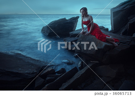 A sad woman near the sea in evening A sad woman near the sea in evening 36065713
