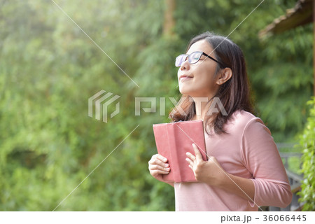 Happy Beautiful Asian woman holding book. 36066445