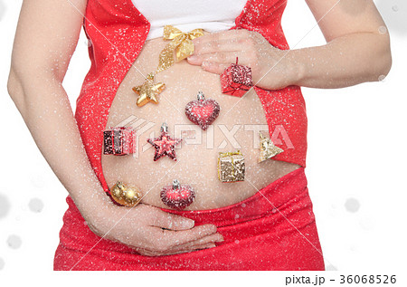 Belly of pregnant woman with Christmas decorations 36068526