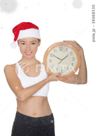 smiling asian women in a Santa's hat with a clock smiling asian women in a Santa's hat with a clock 36068530
