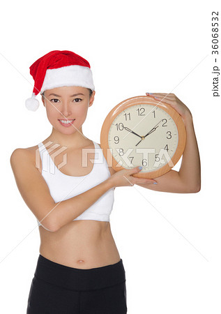 happy asian women in a Santa's hat with a clock happy asian women in a Santa's hat with a clock 36068532