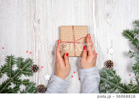 Gift box in hands with Christmas background Gift box in hands with Christmas background 36068816