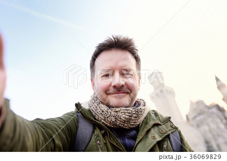 man making a self portrait with Neuschwanstein 36069829