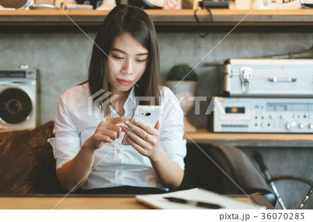 Young woman using smartphone. 36070285