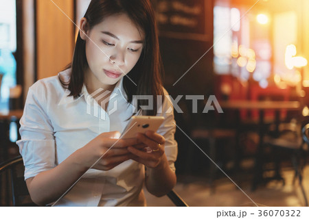 Young woman using smartphone. 36070322