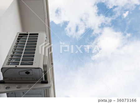 Air compressor unit is hanging near the wall. 36073166