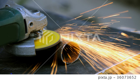 Worker cutting metal with grinder Worker cutting metal with grinder 36073652