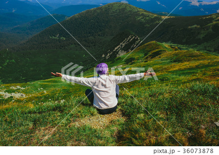 woman traveler sitting on mountainous landscape woman traveler sitting on mountainous landscape 36073878