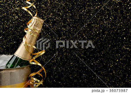 Bottle of champagne in a bucket on dark backgroud Bottle of champagne in a bucket on dark backgroud 36073987
