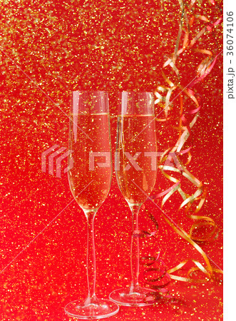 Champagne flutes on red holiday background 36074106
