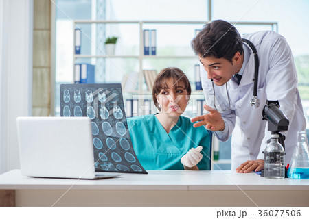 Two doctors discussing x-ray MRI image in hospital Two doctors discussing x-ray MRI image in hospital 36077506