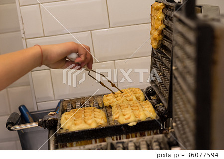 Cooking Belgian waffles in bakery - food Cooking Belgian waffles in bakery - food 36077594