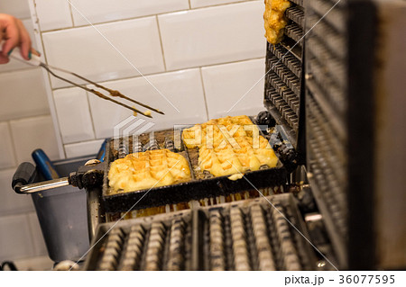 Cooking Belgian waffles in bakery - food Cooking Belgian waffles in bakery - food 36077595