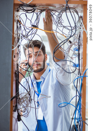 Electrician trying to untangle wires in repair Electrician trying to untangle wires in repair 36078049
