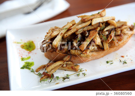 Crispy toasted white bread with mushrooms on wood background table 36080560