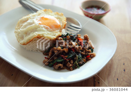 stir fried pork and basil with rice and egg on wood background thai food 36081044