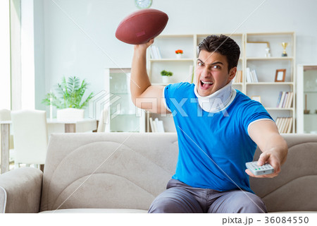 Man with neck injury watching american football at Man with neck injury watching american football at 36084550