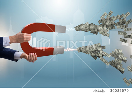 Businessman catching dollars on horseshoe magnet Businessman catching dollars on horseshoe magnet 36085679