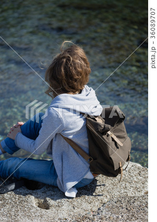 Woman tourist with camera and backpack sitting and 36089707