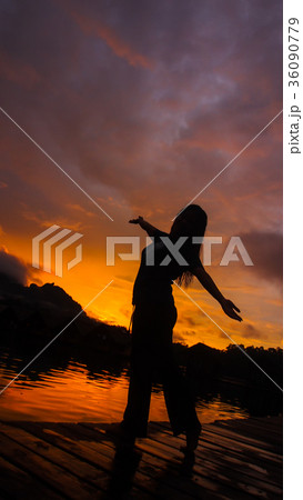 Silhouette of woman with sunset light background. Silhouette of woman with sunset light background. 36090779