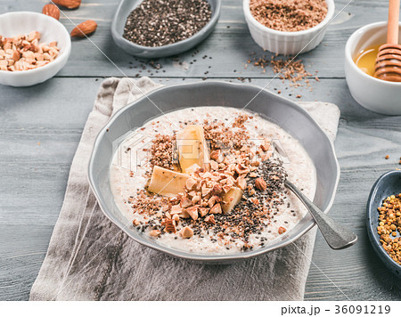 Overnight oats in bowl and ingredients on gray 36091219