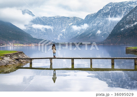 Woman on a deck over an alpine lake Woman on a deck over an alpine lake 36095029