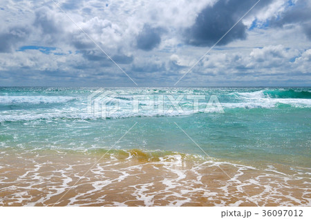 sandy beach of tropical ocean and  overcast sky. 36097012