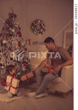 Father with son at home on Christmas evening Father with son at home on Christmas evening 36098617