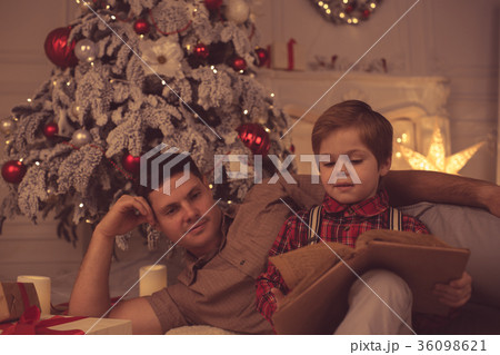 Father with son at home on Christmas evening Father with son at home on Christmas evening 36098621