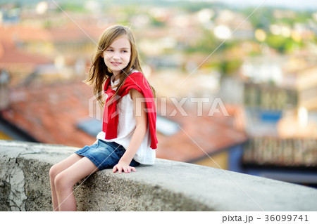 Adorable girl on warm and sunny summer day in Desenzano del Garda town in Italy 36099741