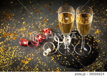 Two champagne glasses in golden glitter Two champagne glasses in golden glitter 36099924