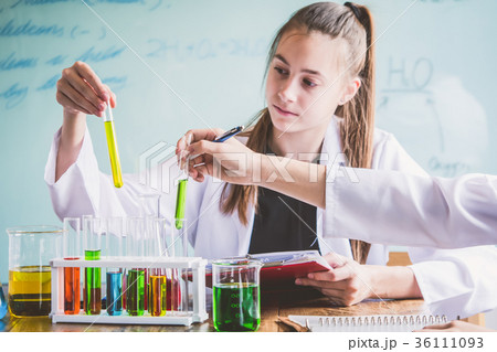 Couple of students working at chemistry class. Couple of students working at chemistry class. 36111093