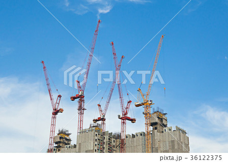 Tower cranes in building site on blue sky Tower cranes in building site on blue sky 36122375
