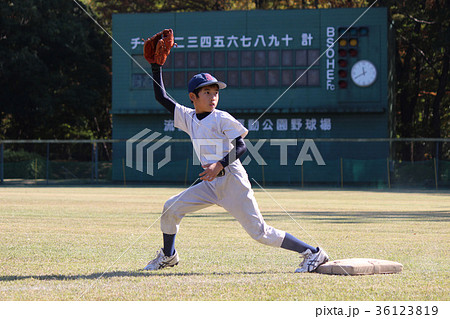 ファーストでアウトを審判にアピールしている野球少年の写真素材
