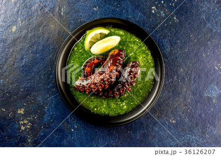 Grilled octopus serves with grin sauce on black 36126207