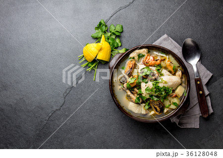 Seafood Soup in clay bowl on gray slate background Seafood Soup in clay bowl on gray slate background 36128048