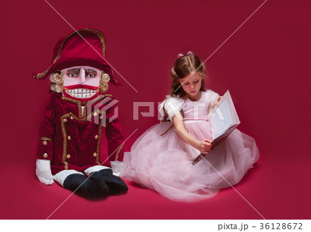 The beauty ballerina sitting with nutcracker The beauty ballerina sitting with nutcracker 36128672