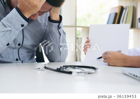 Man patient having a migraine headache and female doctor in the Man patient having a migraine headache and female doctor in the 36139453