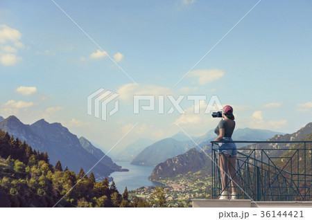 A female photographer with a camera on the balcony 36144421