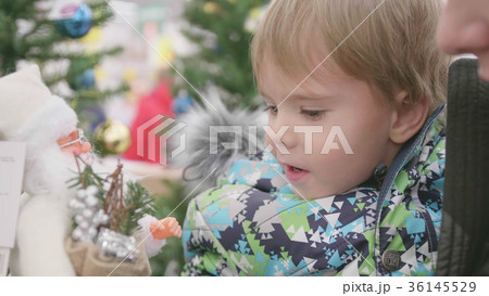 Father and son choose a Christmas gift in the Father and son choose a Christmas gift in the 36145529