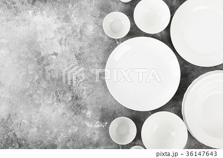 Clean white tableware on a gray background Clean white tableware on a gray background 36147643
