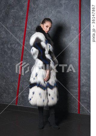 Attractive girl in long bouffant fur coat  36147867